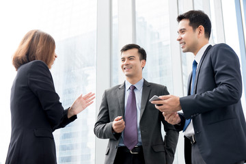Fototapeta premium Group of business people talking at building hallway in the office