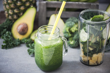 Green smoothie with ingredients in blender