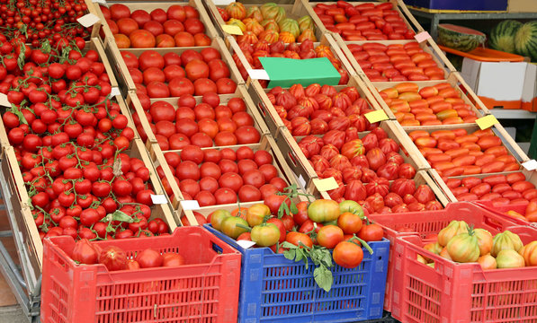 Many ripe tomatoes in the boxes on sale