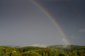 Rainbow over foggy land. Magnificent landscape. Natural look.