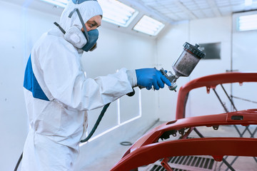 Painting the car's bumper red on the service.