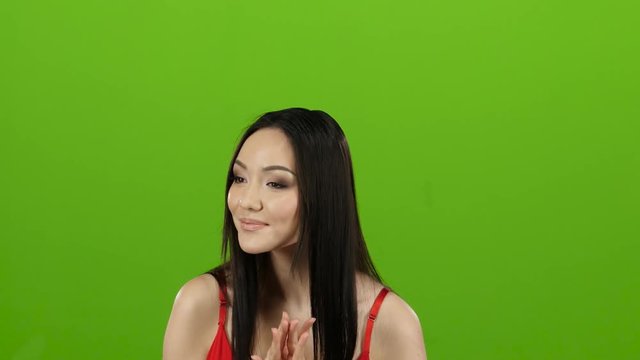 Girl came to the store for shopping and can not choose clothes. Green screen