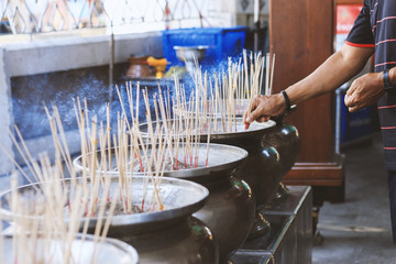 closeup incense burner with soft-focus and over light in the background