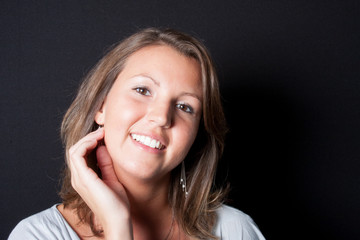 cheerful girl in black background smile and happy