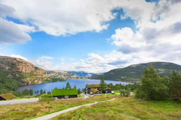 Fototapeta na wymiar Beautiful landscape of Norway homes with green roofs and, mountainous terrain and reservoirs