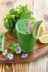 fruit and vegetable green smoothie on a wooden table