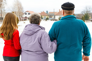 Elderly couple and young caregiver