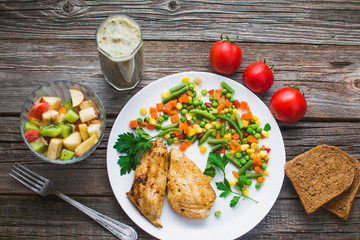 Breakfast on the wooden background from chicken breast