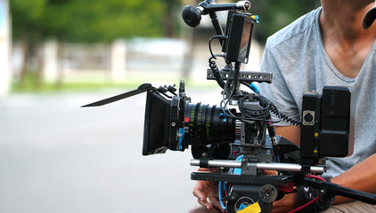 Behind the scenes of movie shooting or video production at outdoor location with high quality...