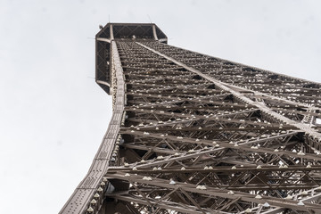 Paris, France - April 29, 2016: the Eiffel Tower from the bottom. Constructed from 1887–89 as the entrance to the 1889 World's Fair, it is a wrought iron lattice tower on the Champ de Mars in Paris