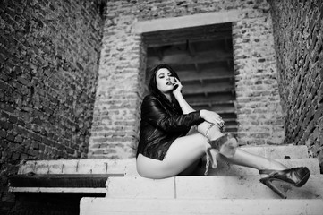 Brunette plus size sexy woman, wear at black leather jacket, lace panties, bra and high heels with...