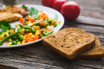 Breakfast on the wooden background from chicken breast
