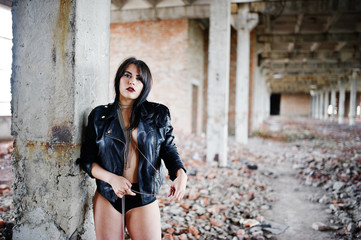 Brunette plus size sexy woman, wear at black leather jacket, lace panties at abadoned place....