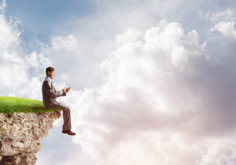 Businessman in suit with smartphone in hands send message