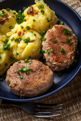 Meatballs served with boiled potatoes.