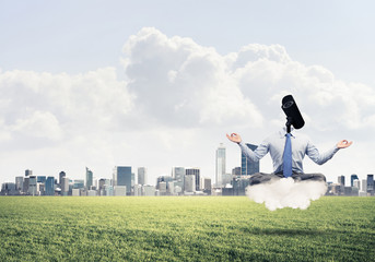 Obraz premium Camera headed man sitting in lotus pose on cloud against modern 