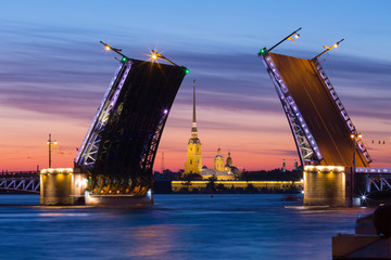 Fototapeta na wymiar Open Palace Bridge and view of the Peter and Paul Fortress in St.Petersburg in white night