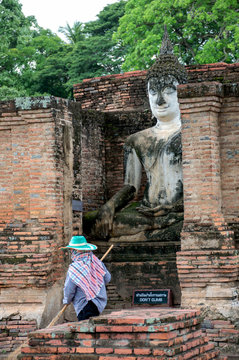 A worker is cleaning the grounds of world heritage site,Sukhothai.