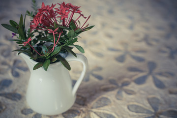 flowers in a vase on wooden table with copy space
