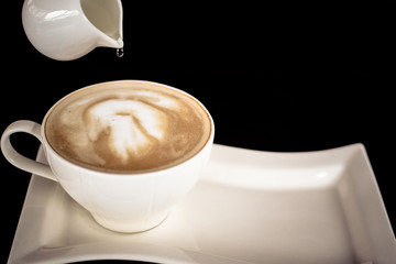 Beautiful late coffee on black wood background.
