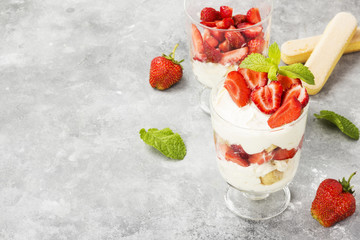 Dessert tiramisu with strawberry on a gray background. Copy space. Food background