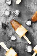 Coffee ice cream popsicles on a dark background. Top view. Food background