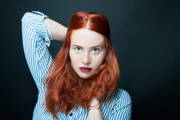 Fototapeta premium Beautiful and confident woman with long red hair