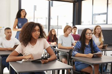 Teacher stands at the back of her high school class