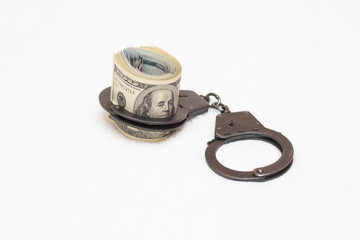 Money dollars and manacles isolated on white background