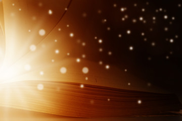 Image of opened magic book with star lights