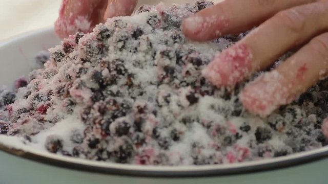 The cook prepares jam from the black currant