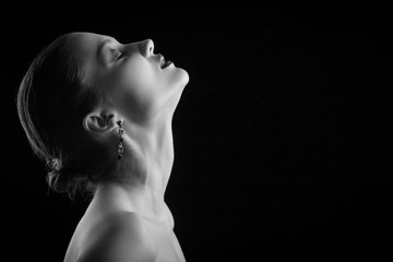 sensual luxury woman aroused on black background, monochrome