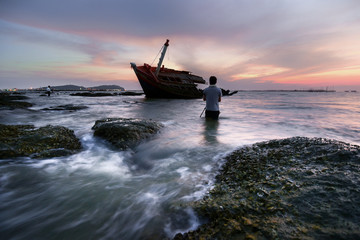An old shipwreck or abandoned shipwreck.,Wrecked boat abandoned stand on beach or Shipwrecked off...