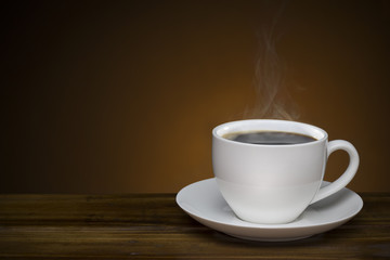 black coffee with smoke - hot coffee cup on wooden table with copy space good for text and graphic design