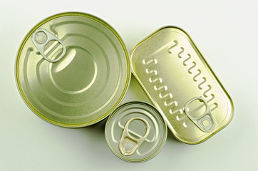Close-up view of various tins and cans on white background
