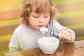 Cute toddler girl having breakfast