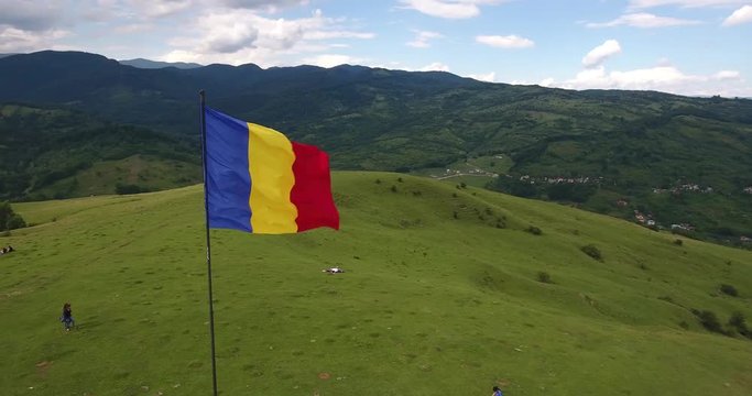 Romanian Flag blowing in the wind. 4K video footage taken with a drone