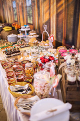 Candy bar on wedding ceremony with a lot of different candies and beverages
