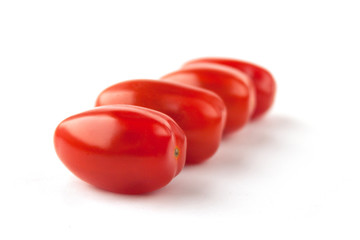  Four tomatoes on a white background with shadows