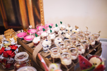 Candy bar on wedding ceremony with a lot of different candies and beverages