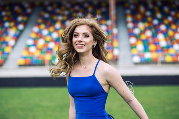 Happy young woman on stadium laughing