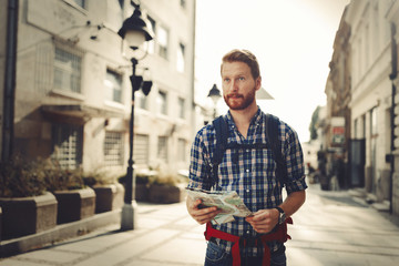 Tourist holding map and sightseeing in city