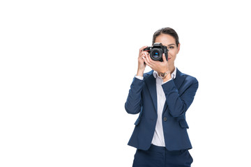 beautiful female photographer taking photo on professional camera, isolated on white