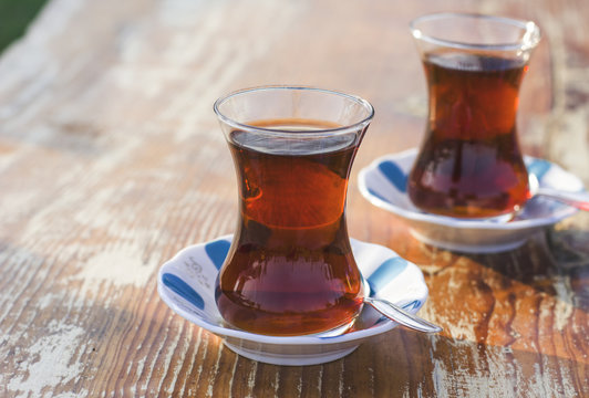 Black herbal turkish tea in traditional glass at the street cafe