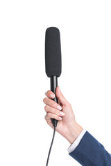 cropped view of female hand holding microphone for interview, isolated on white