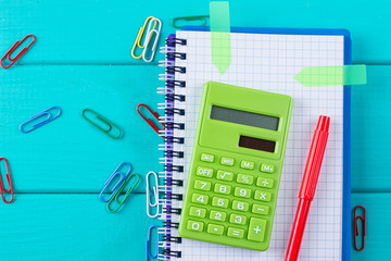 Calculator and pencil on notepad