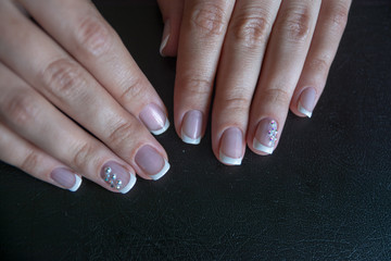 Lacquer on the nails of the hands. Fresh French manicure