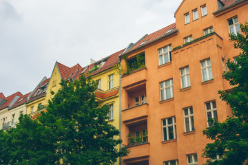 white, yellow and orange houses on a cloudy day