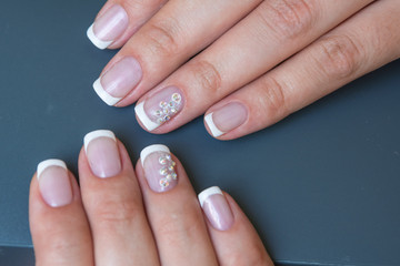 Lacquer on the nails of the hands. Fresh French manicure