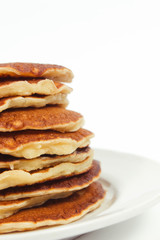 A stack of plain pancakes on a white plate background. isolated